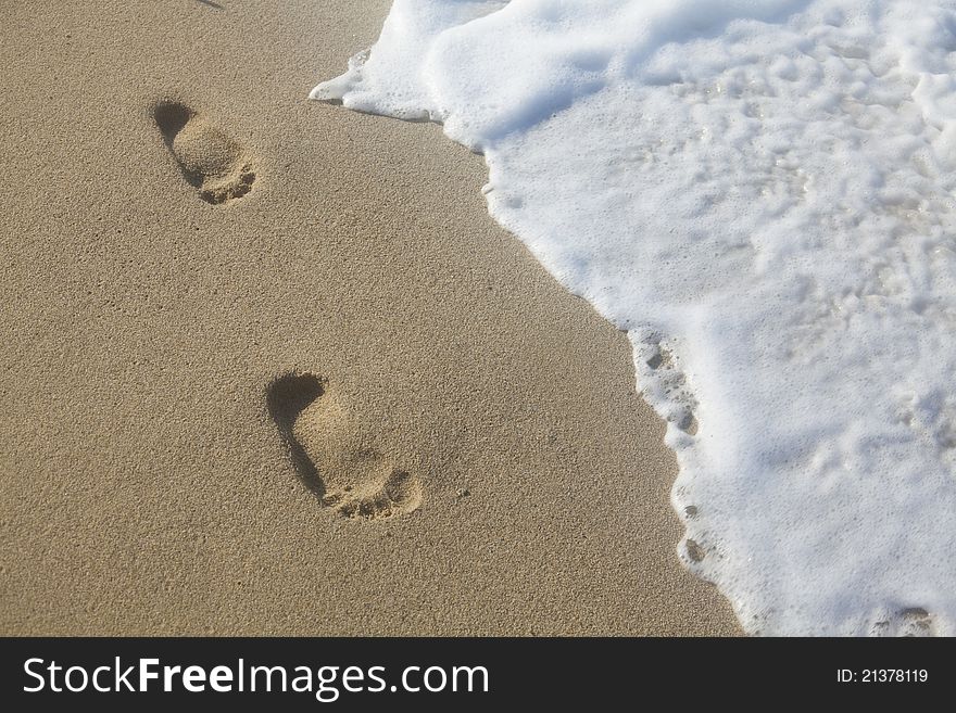 Human footmarks on the sandy beach