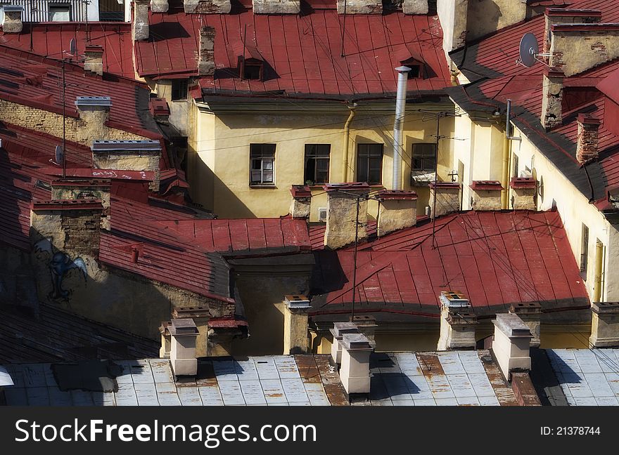 Old houses with red metal roofs. Old houses with red metal roofs