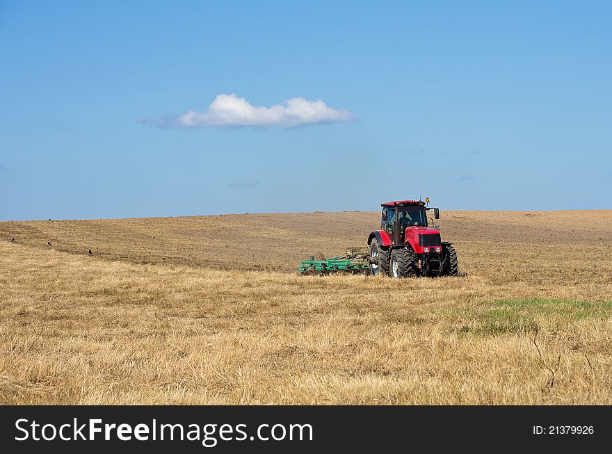 Tractor with cultivator handles field before planting. Tractor with cultivator handles field before planting