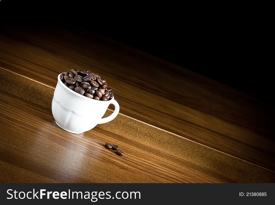 Cup of coffee on wood and black background. Cup of coffee on wood and black background