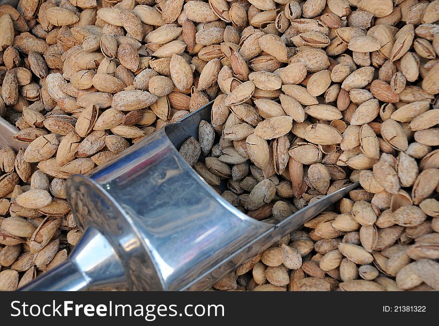 Unshelled Almonds And Metal Scoop