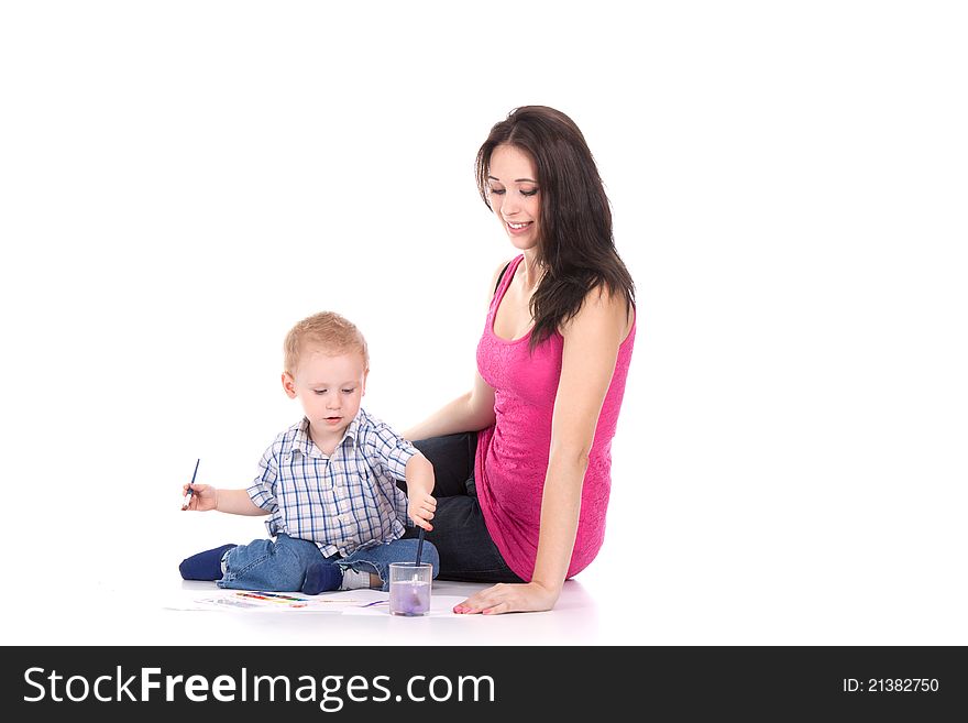 Happy young mother and son painting over white. Happy young mother and son painting over white