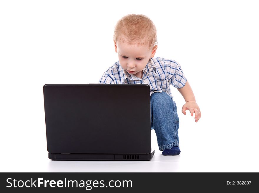 Little boy sitting with laptop over white background