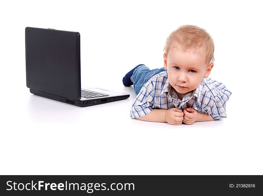 Little boy sitting with laptop over white background