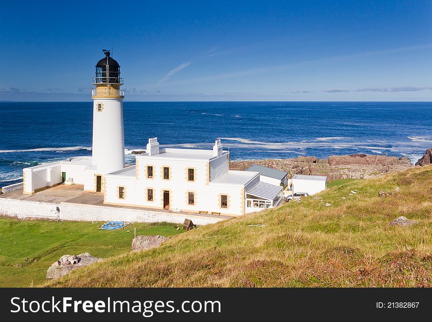Lighthouse from above with sunny sea and sky behind. Lighthouse from above with sunny sea and sky behind