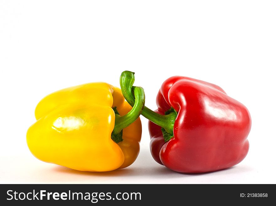 Two red and yellow peppers together. Two red and yellow peppers together