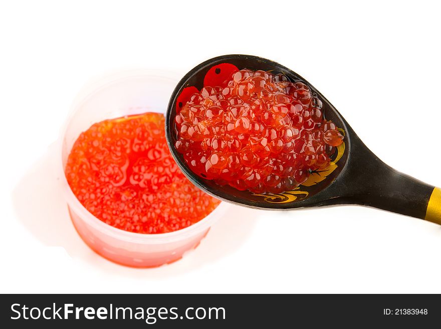 Red caviar heap in wooden spoon