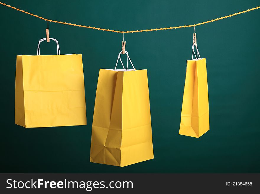 Shopping yellow gift bags on green