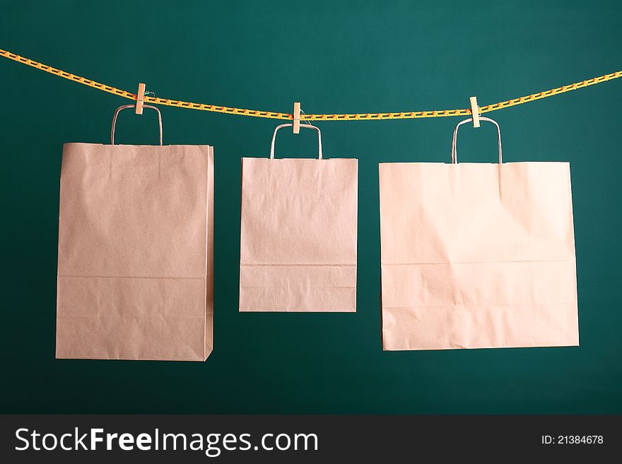 Paper Shopping gift bags on green background ecologocal. Paper Shopping gift bags on green background ecologocal