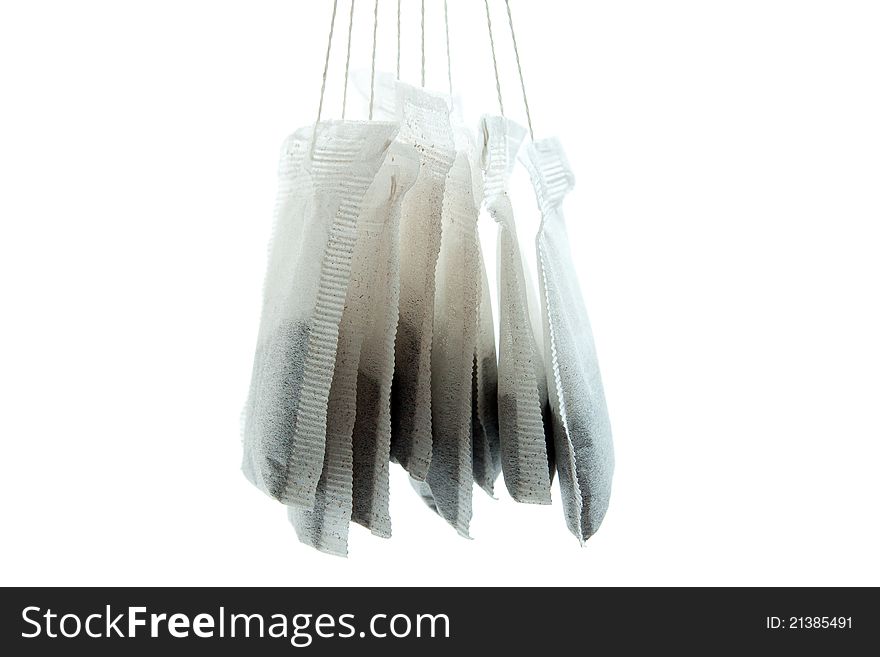 Hanged a couple of tea bag with white background in Close Up. Hanged a couple of tea bag with white background in Close Up