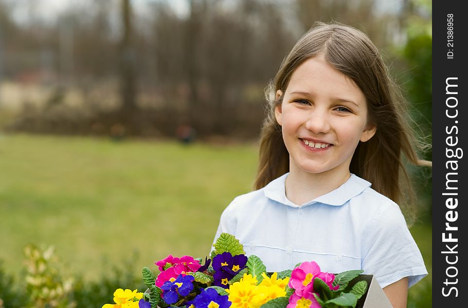 Girl holding the box with colorful pansy flower. Girl holding the box with colorful pansy flower