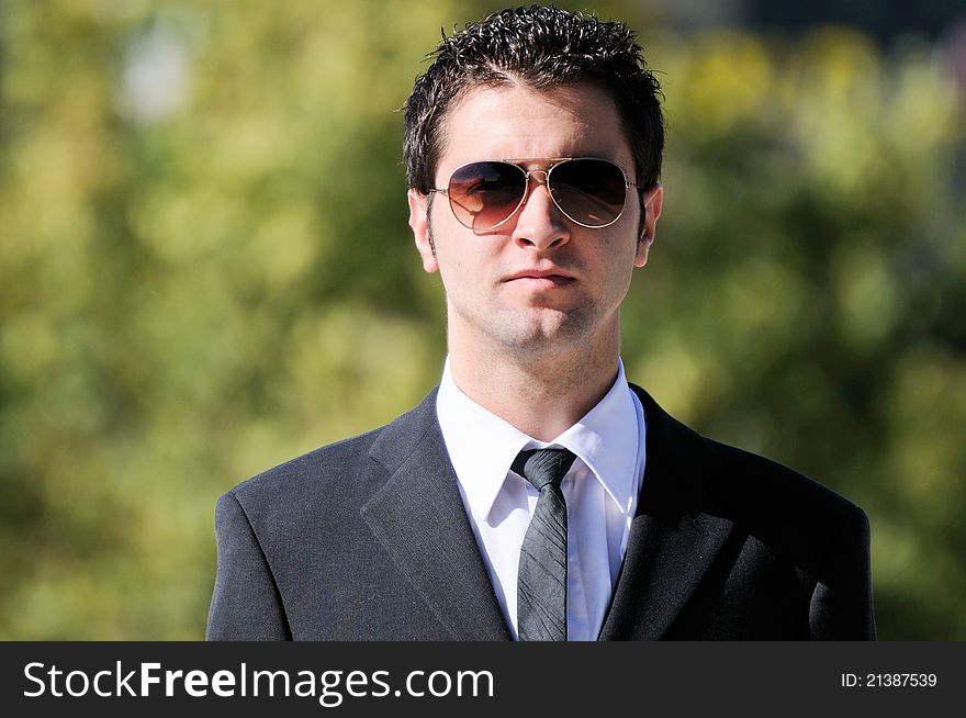 A portrait of a young businessman with sunglasses