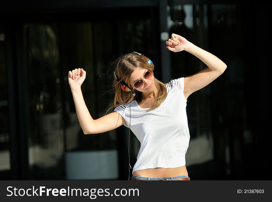 Young Girl With Headphones In The Street