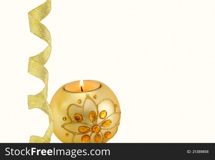 Candle with Christmas decorations and a golden ribbon at the bottom, on white background. Candle with Christmas decorations and a golden ribbon at the bottom, on white background