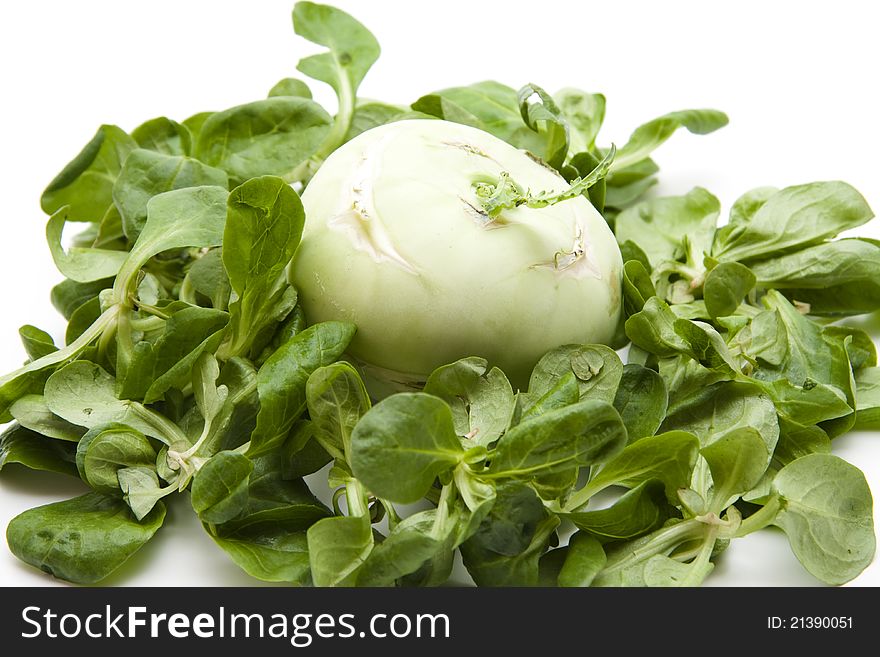 Kohlrabi in the corn salad and on white background