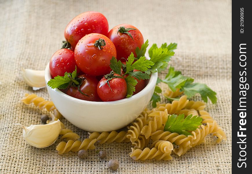 Fresh tomato in bowl with pasta. Selective focus. Fresh tomato in bowl with pasta. Selective focus