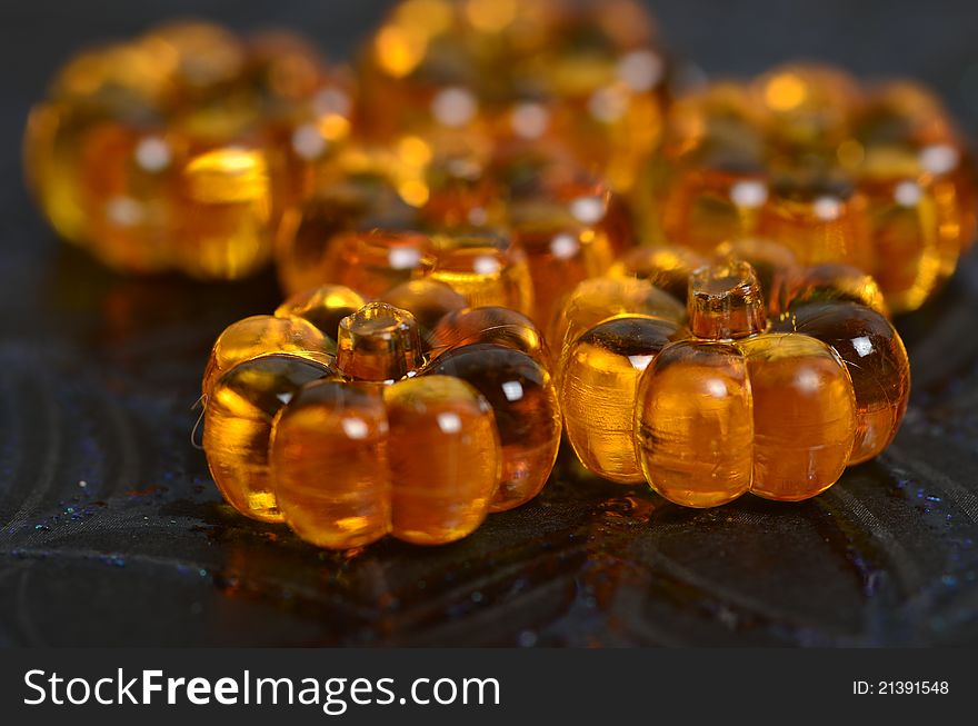 A shiny close up of crystal pumpkins on a spider web background. A shiny close up of crystal pumpkins on a spider web background