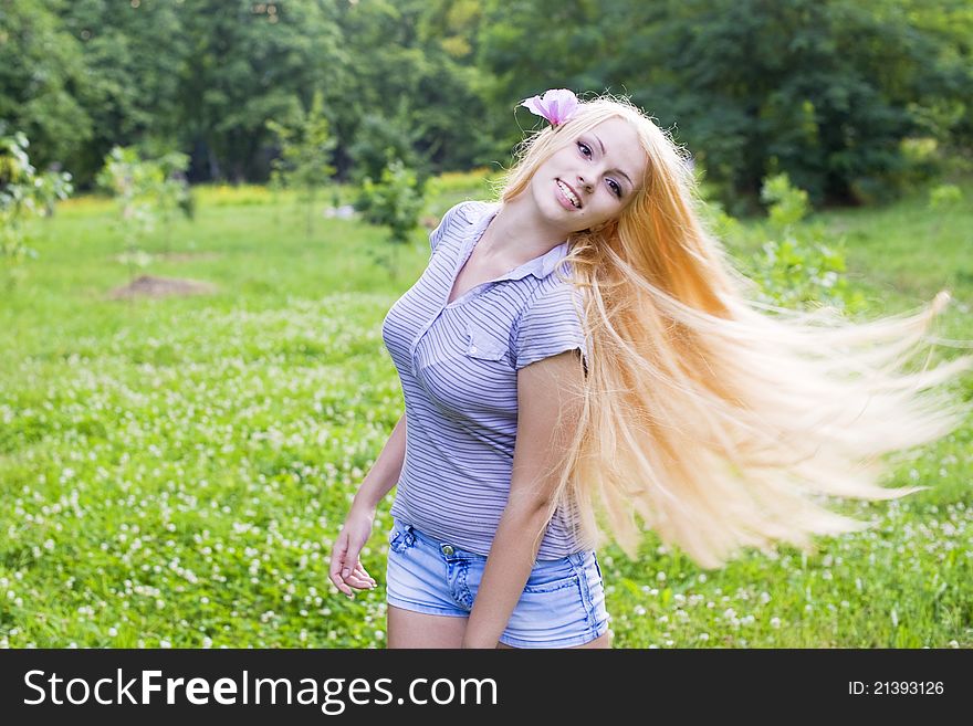 Sexy young female smiling in a park