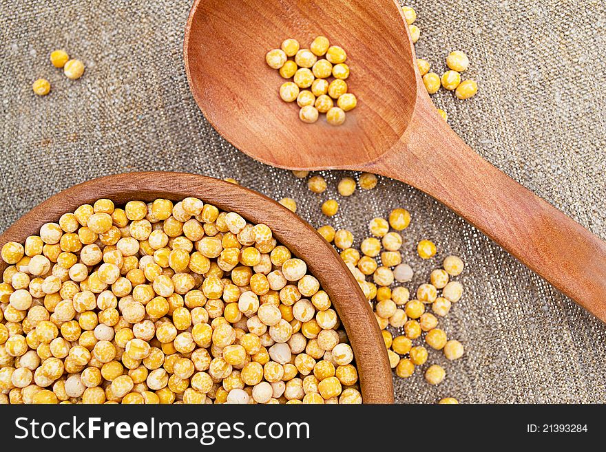 Peas in a wooden bowl with a spoon