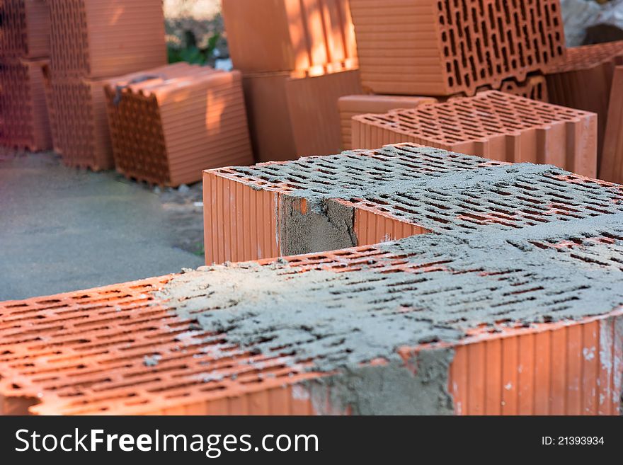 Closeup of some  bricks at a construction site involving plastering