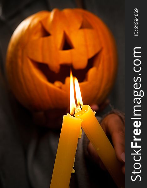 Mystic shoot - halloween glowing pumpkins with two glowing candles in darkness