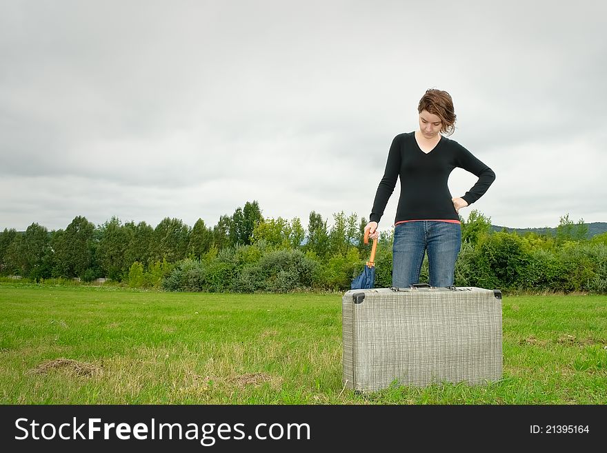 Traveler woman having a rest on the grass. Traveler woman having a rest on the grass