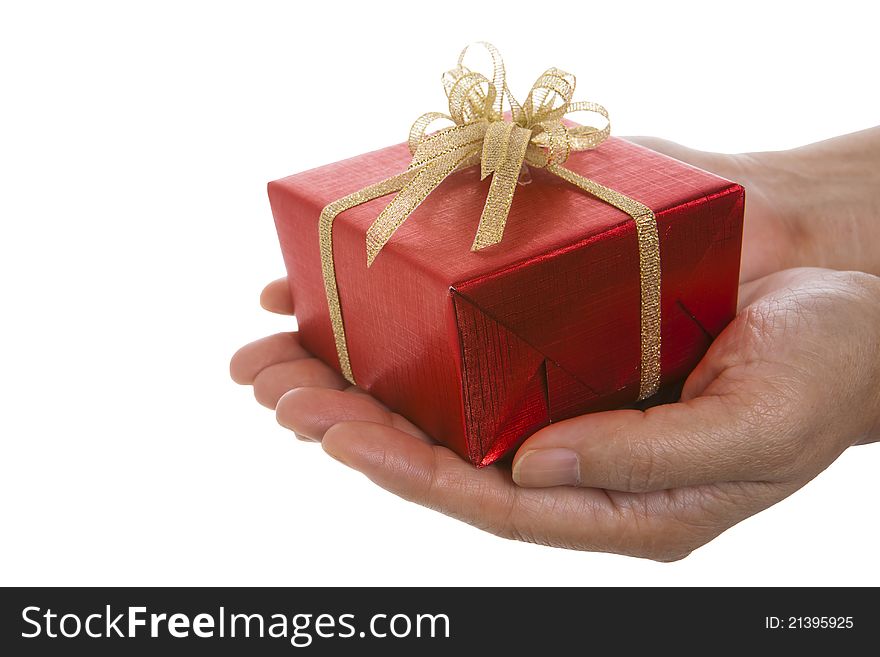 Red gift box on hands over the white background