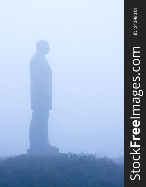 A statue viewed on a foggy day. A statue viewed on a foggy day