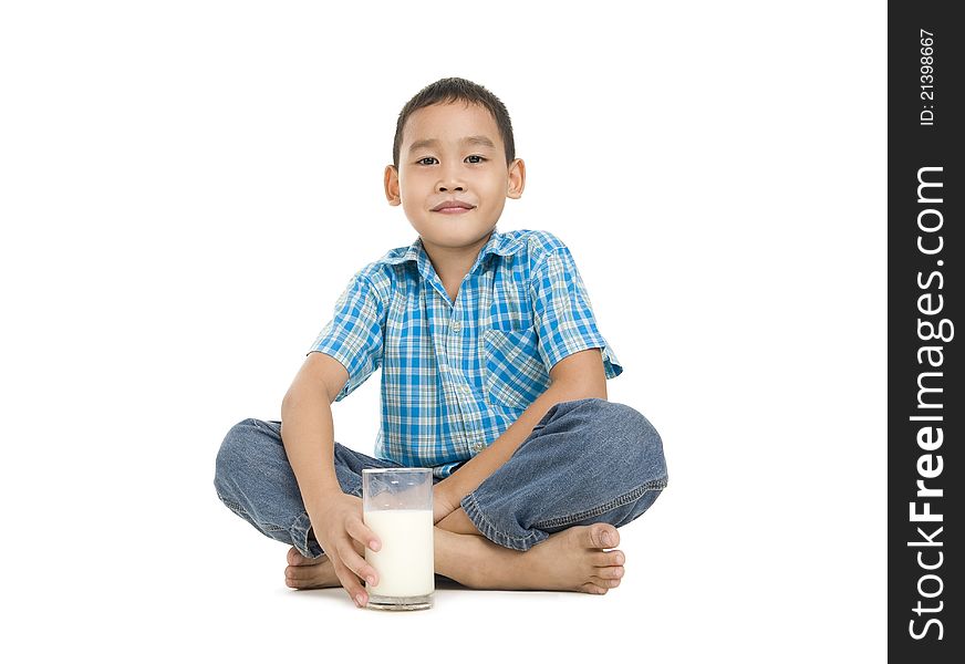 Asian boy sitting with a glass of milk, isolated on white background