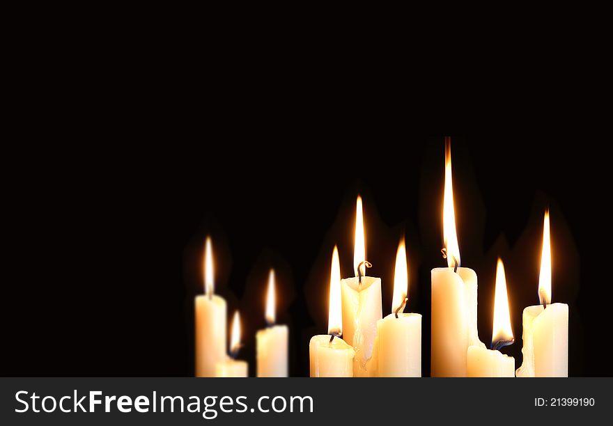 Nine ordinary lighting candles on black background with free space for your text. Nine ordinary lighting candles on black background with free space for your text