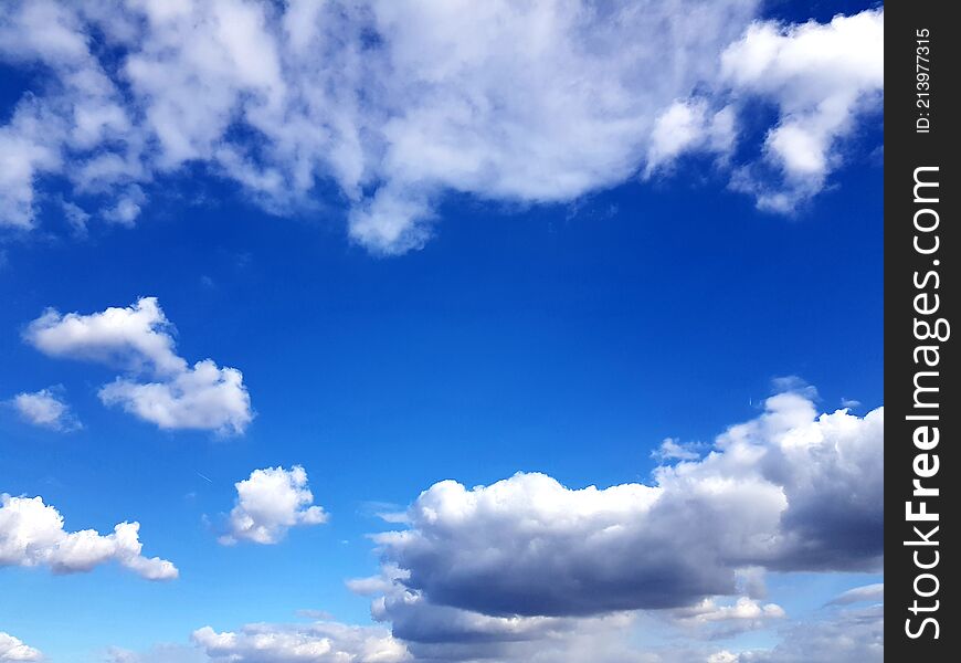 Blue summer sky with white clouds in background. Blue summer sky with white clouds in background