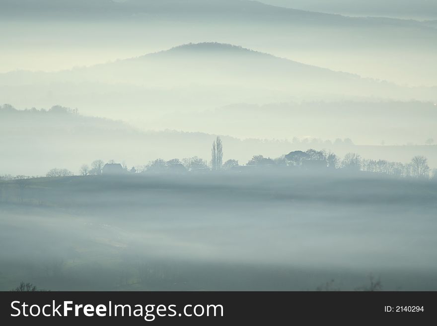 Misty village with mountain in backgroud