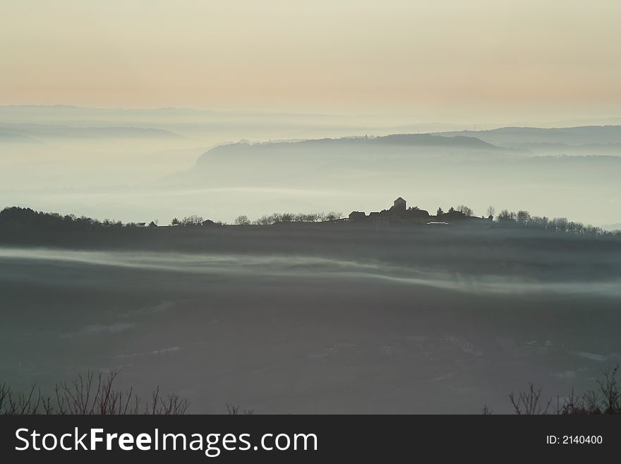 Misty village at sunset france