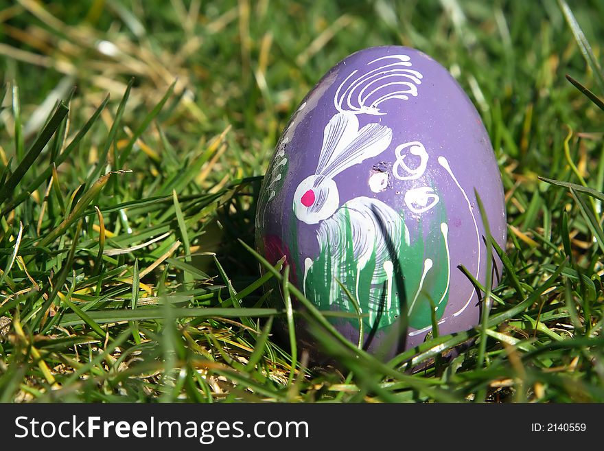 Purple painted  easter egg with green background for europe