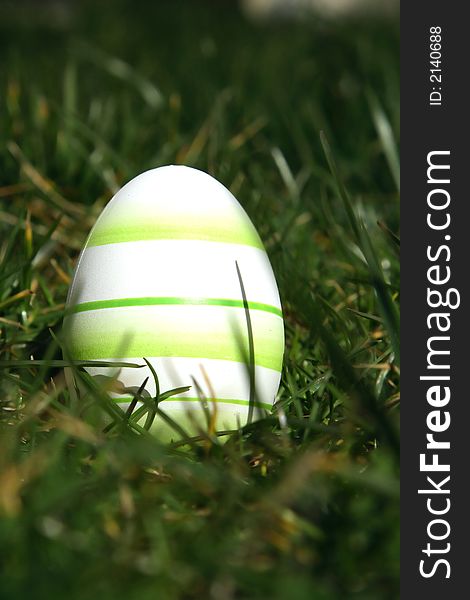 Green painted easter egg with green background