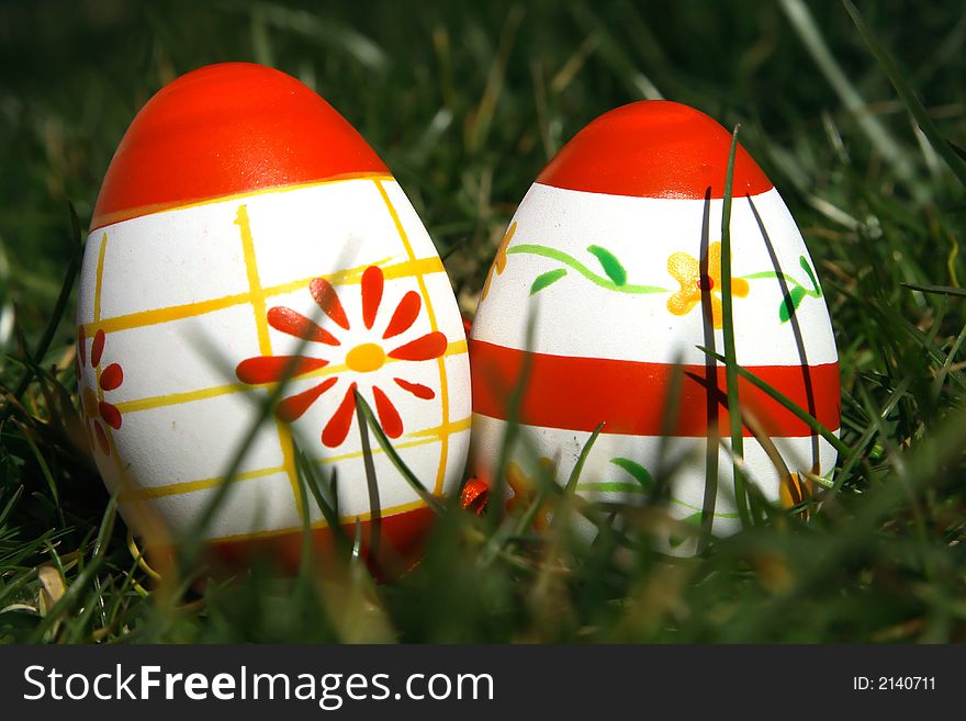 Two red and white painted  easter egg with green background for europe. Two red and white painted  easter egg with green background for europe