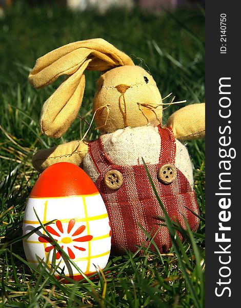 Red and white painted  easter egg andrabbit with green background for europe. Red and white painted  easter egg andrabbit with green background for europe