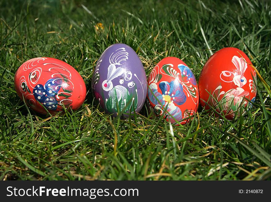 Red and purple painted  easter eggs with green background for europe