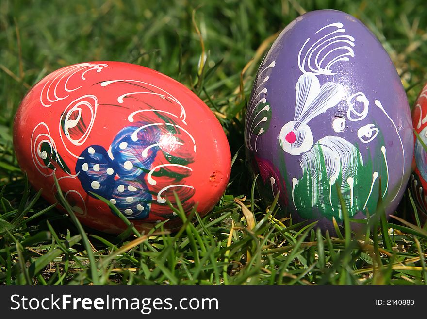 Red and purple painted  easter eggs with green background for europe