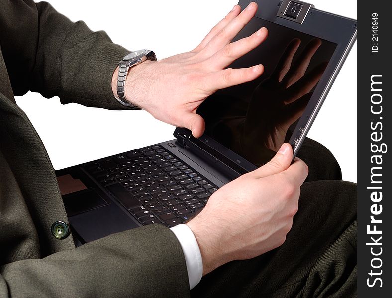 Businessman gesturing negative emotion to his laptop. Businessman gesturing negative emotion to his laptop