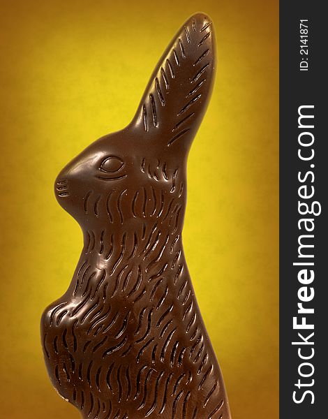 Chocolate easter bunny against a vibrant yellow background