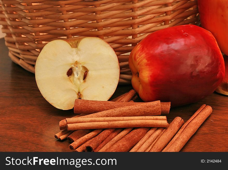 Country lifestyle concept. Showing apples , cinnamon and weaved wicker basket. Country lifestyle concept. Showing apples , cinnamon and weaved wicker basket.