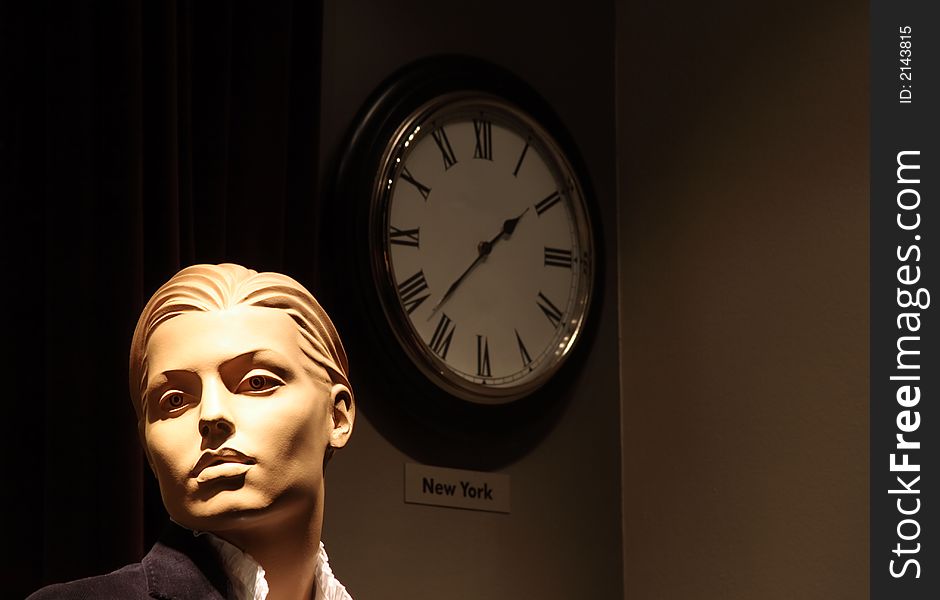 Headshot of a generic mannequin with a wall clock. Background slightly textured, not noise. Headshot of a generic mannequin with a wall clock. Background slightly textured, not noise.