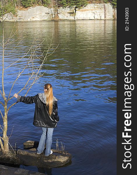 Young lady exploring around the lake, spring has arived. Young lady exploring around the lake, spring has arived.