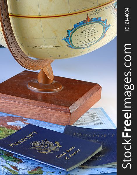 A globe, map & passport with a sky blue backdrop.
 Planning stages of a trip. On the move again. A globe, map & passport with a sky blue backdrop.
 Planning stages of a trip. On the move again.