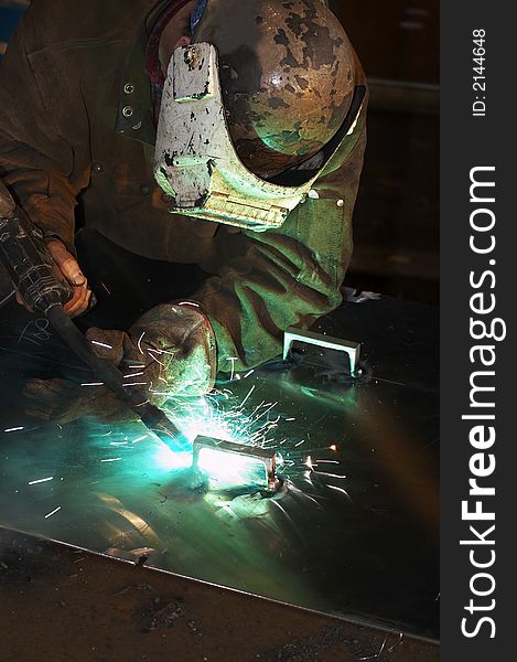 Worker welding aluminum at shipyatd. Worker welding aluminum at shipyatd