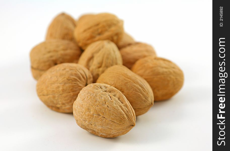 Whole walnuts in shell over the white background