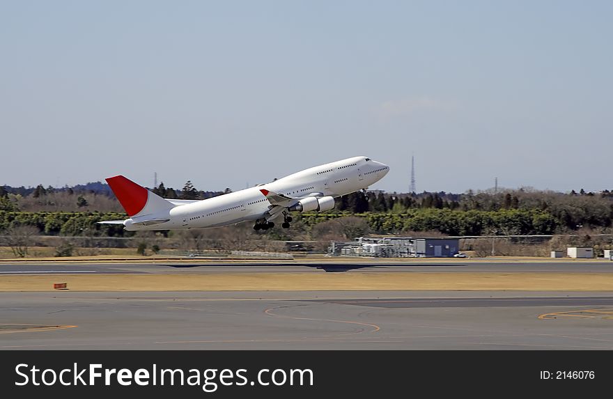 Image of an airplane taking off from an airport. Image of an airplane taking off from an airport.