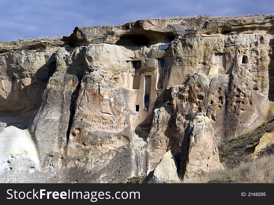 Rock with windows in mountain area near Chavushin, Cappadocia, Turkey