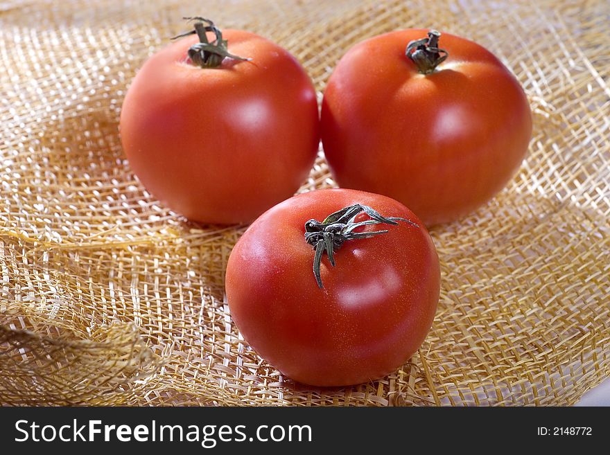 A photo of three tomatoes